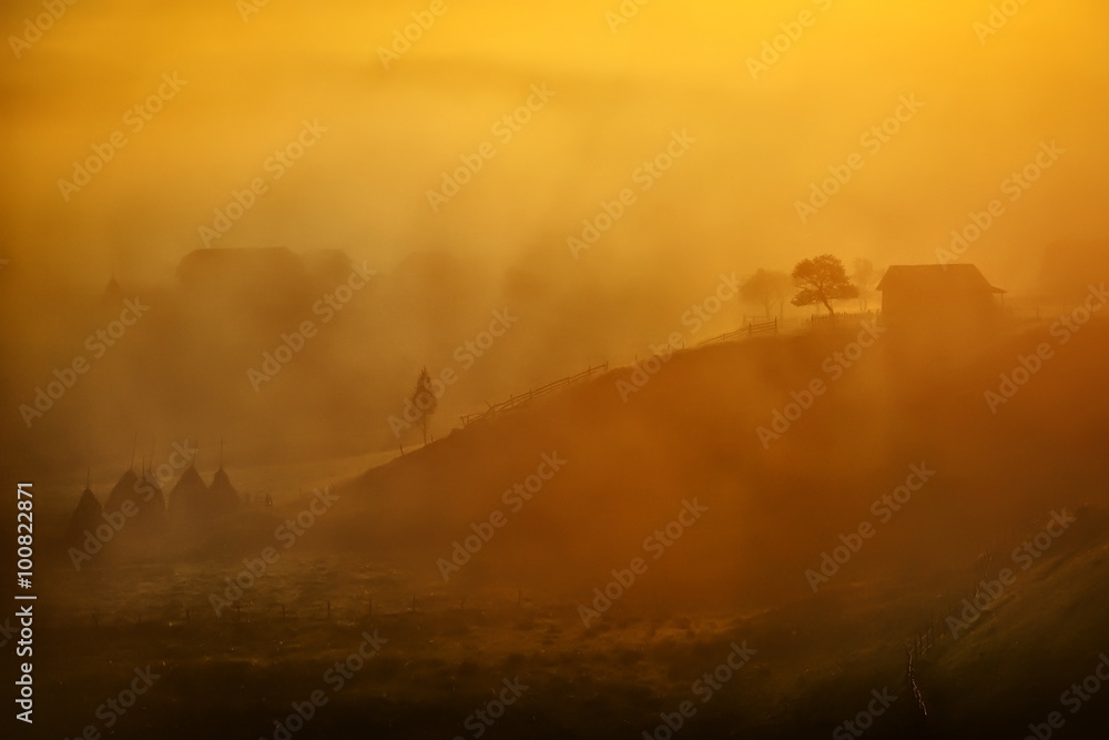 Fototapeta premium mountain landscape in autumn foggy morning, Romania