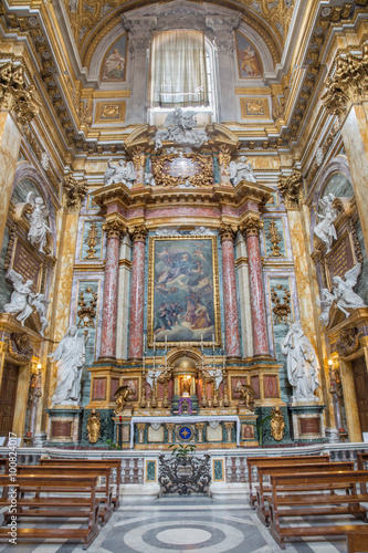 ROME, ITALY - MARCH 25, 2015: Side altar of baroque church Basilica dei Santi Ambrogio e Carlo al Corso with the altarpiece God the Father Being Worshipped by Angels by Tommaso Luini (1601 – 1636)