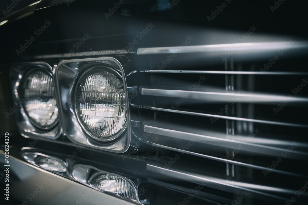 Detail on the headlight of a vintage car.