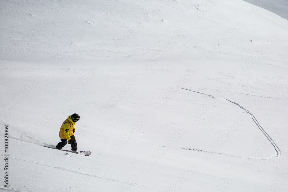 Man snowboarding on snow in the mountains