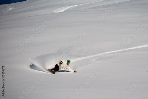 Man snowboarding on snow in the mountains