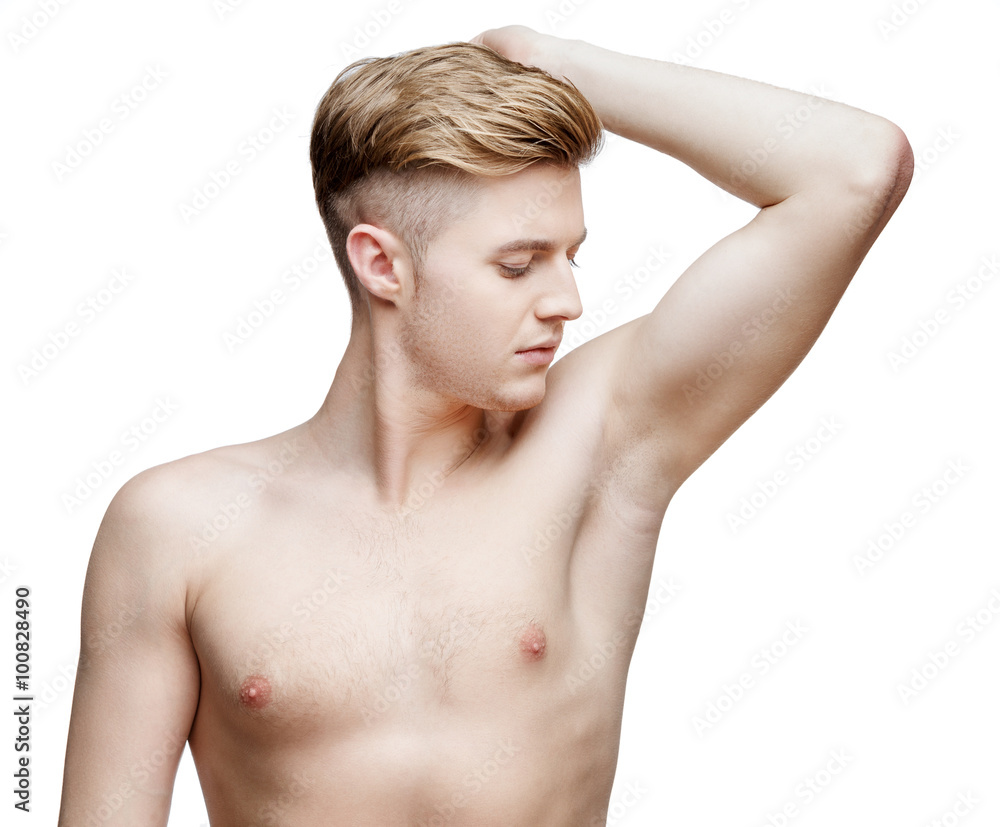 Obraz premium Handsome young man sniffing his armpit