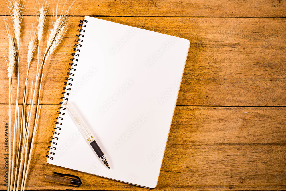 Blank Notebook with Flower on Wooden Table Blank Notebook with Flower on Wooden Table