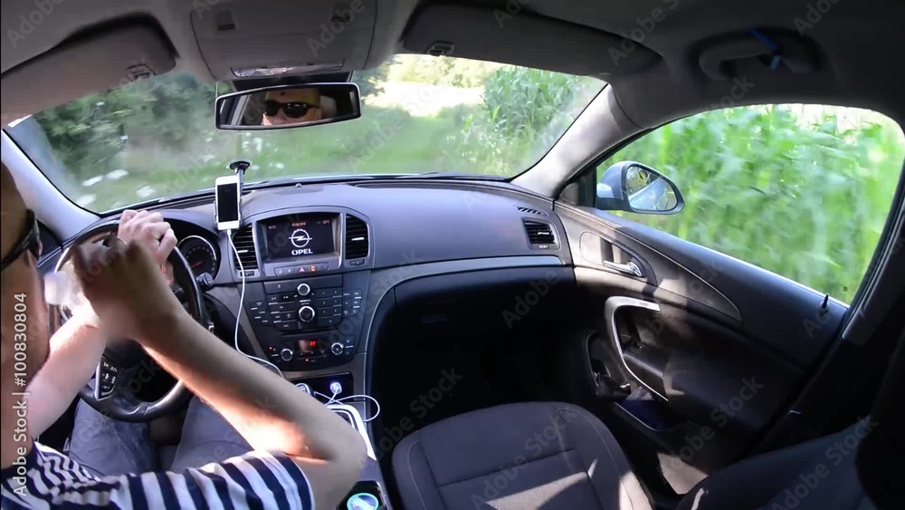 man driving a car with gps navigation system and phone smart phone app man driving a car with gps navigation system and phone smart phone app