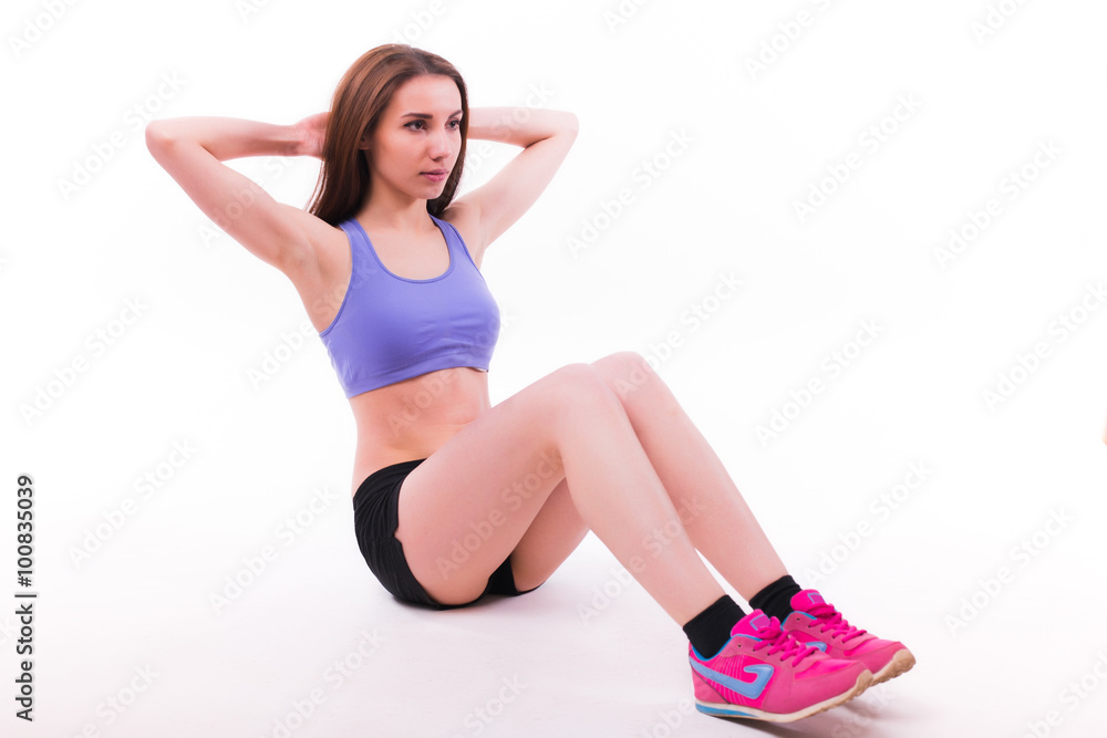 Young woman doing fitness exercise on white isolated background. Young woman doing fitness exercise on white isolated background.