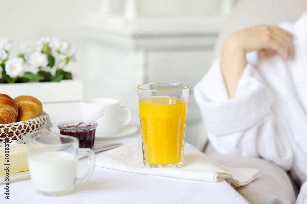 Beautiful woman behind a white table with fresh juice. Beautiful woman behind a white table with fresh juice.