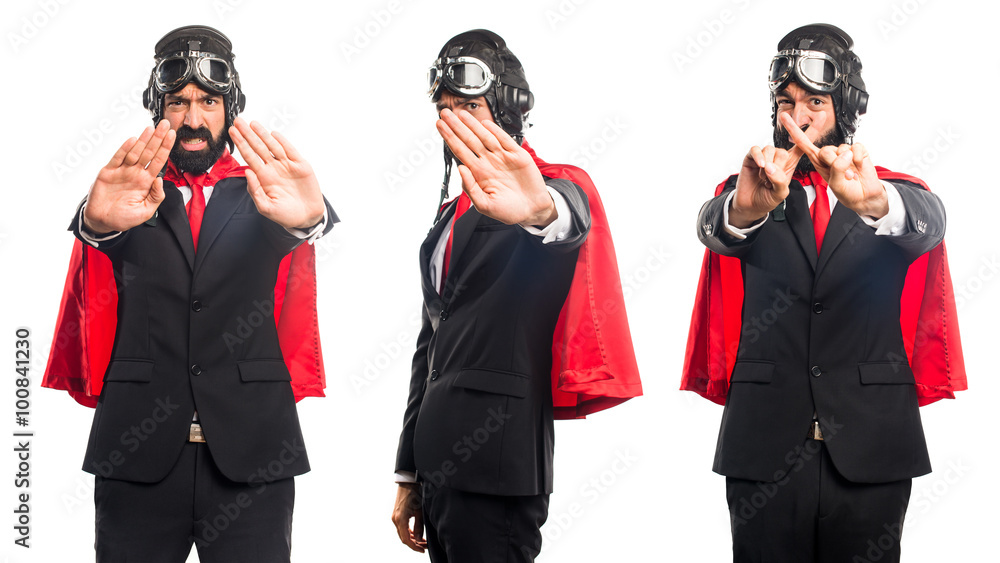 Super hero businessman making stop sign Super hero businessman making stop sign