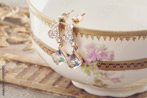 Beautiful shiny earrings on the vintage background
