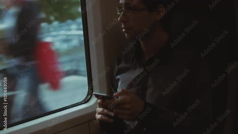 Man Using Phone During Traveling on Train. Shot on RED Cinema Camera. Man Using Phone During Traveling on Train. Shot on RED Cinema Camera.