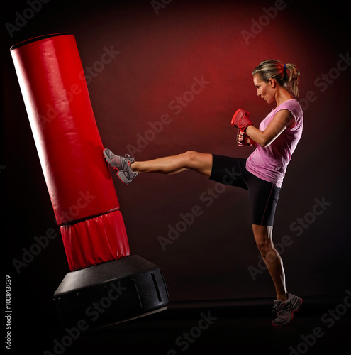 young woman exercising bag boxing photo