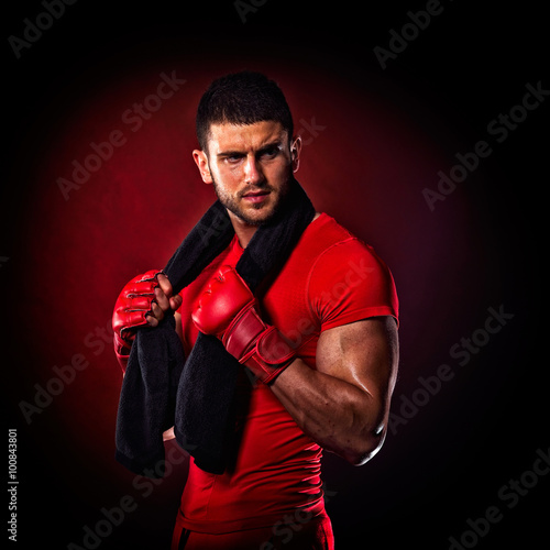 young man standing by bag boxing in studio