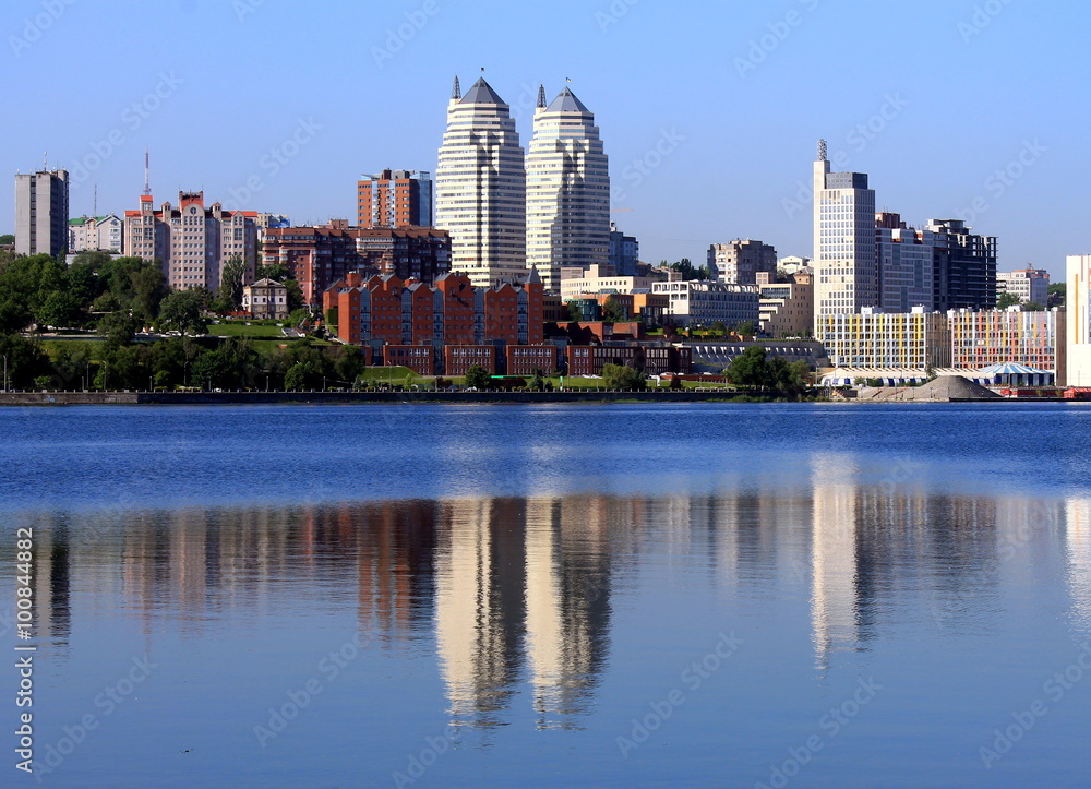 Early morning on the river Dnepr , buildings reflected in the water Dnepropetrovsk, Ukraine .