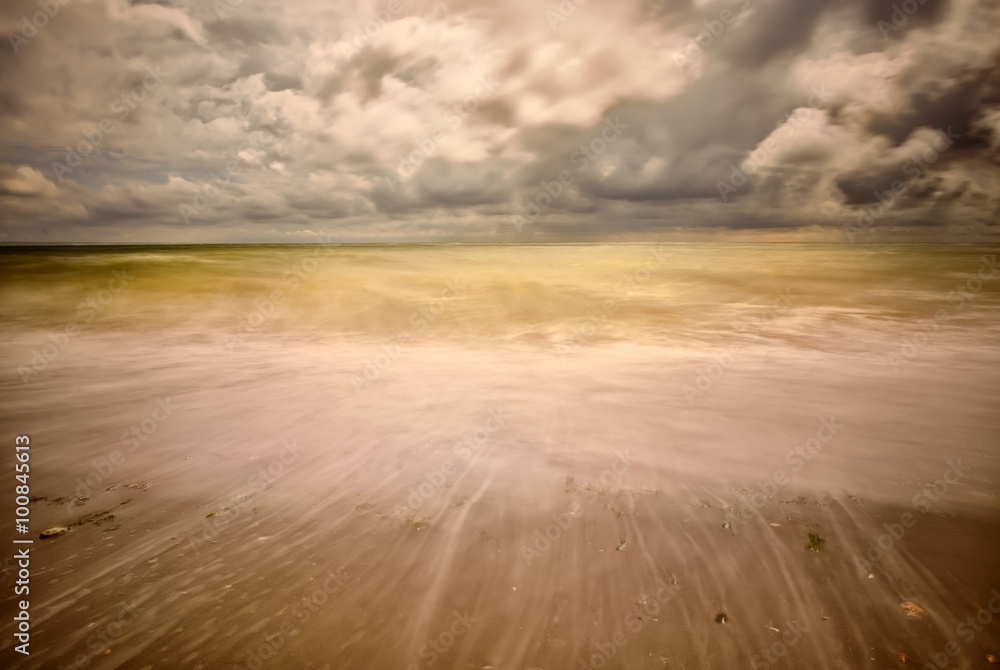 seascape on cloudy summer day - long exposure image