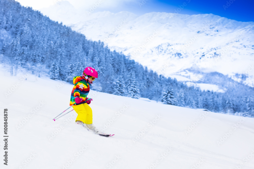 Little girl skiing in the mountains