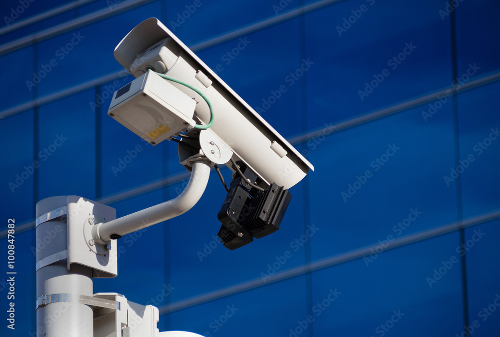 Surveillance camera in front of building Surveillance camera in front of building
