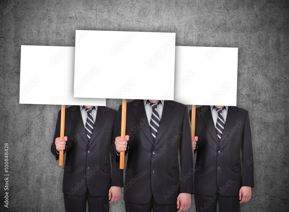 Fotografie Three businessman with a blank banner