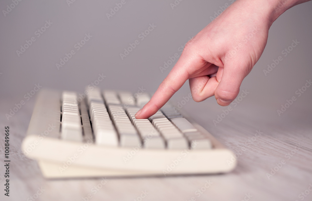 Close up of hand pressing keyboard buttons Close up of hand pressing keyboard buttons