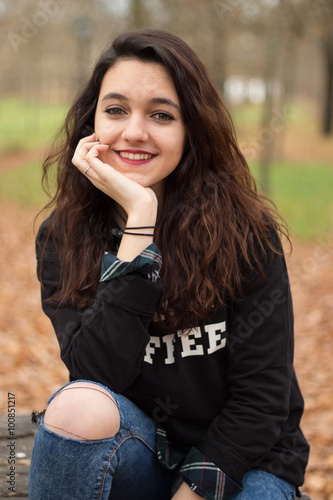 Young girl is posing in the forest in autumn.