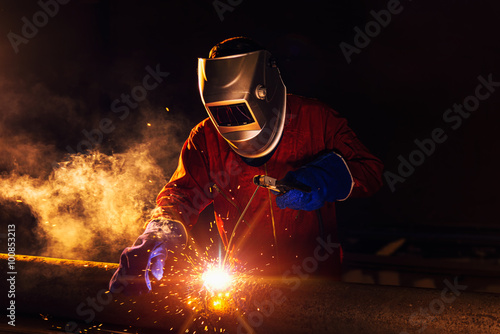 Industrial Worker at the factory welding closeup