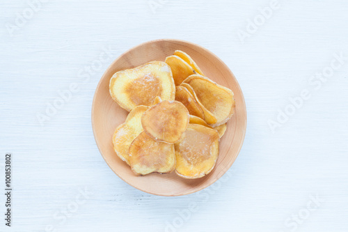 Dried potato slice and coated with sugar