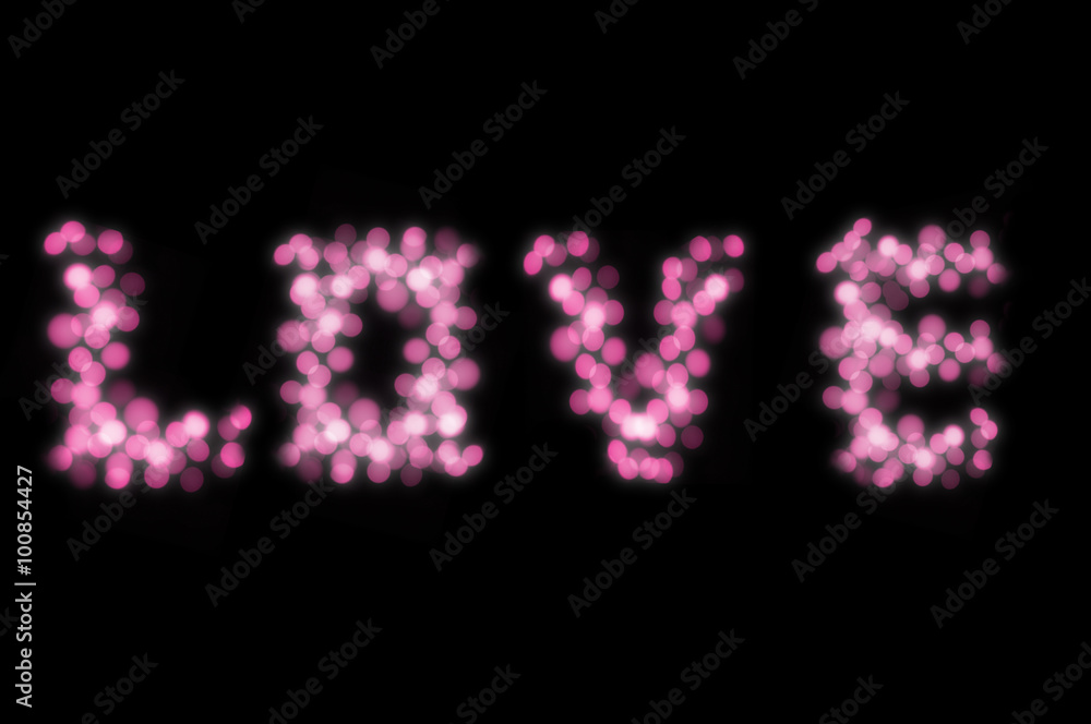 Love text by pink bokeh lights isolated on black background for