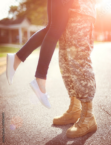 Young military couple kissing each other, homecoming concept, wa photo
