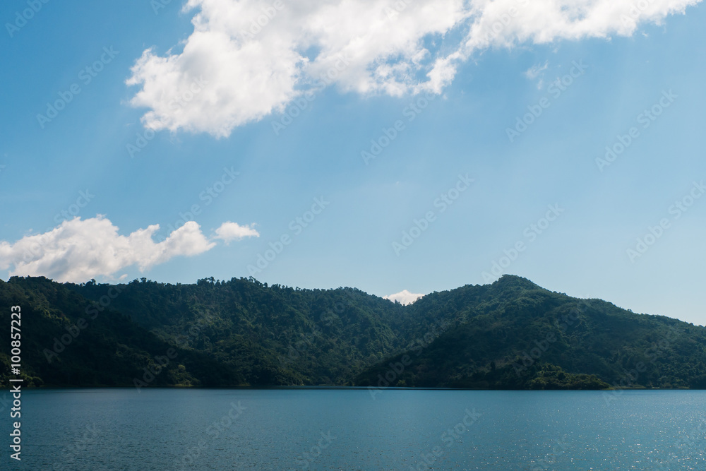 A blue lake, Mountain green forest and sky.