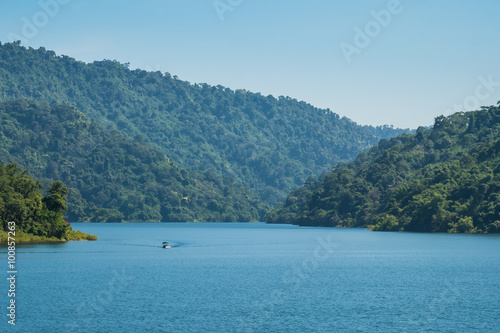 A blue lake, Mountain green forest and boat. © zelelf