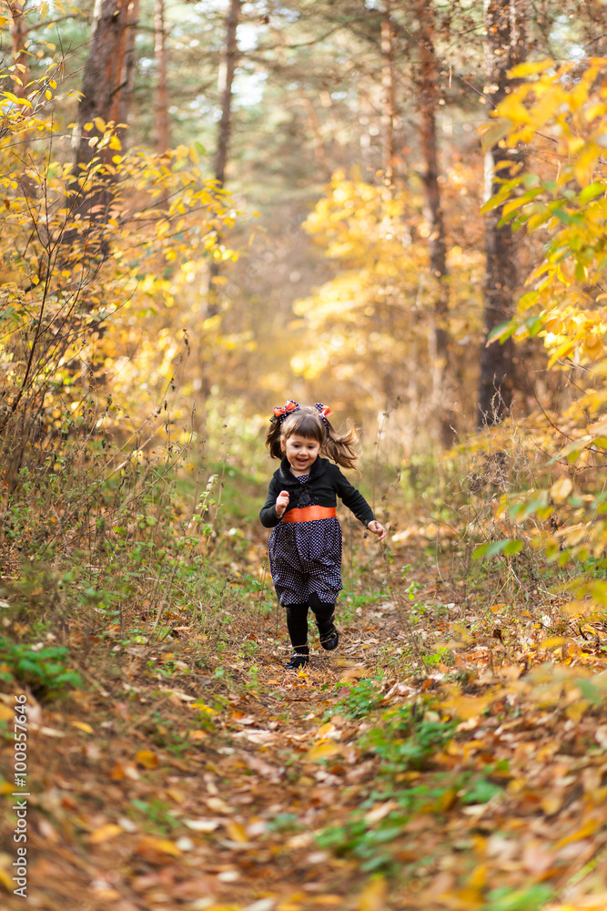 Girl running down the path in the autumn forest Girl running down the path in the autumn forest