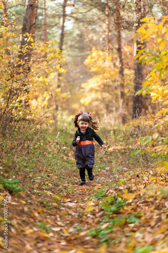 Girl running down the path in the autumn forest © nidvoray