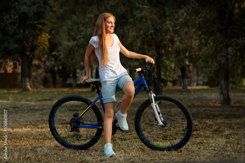 teenage girl and bike in city