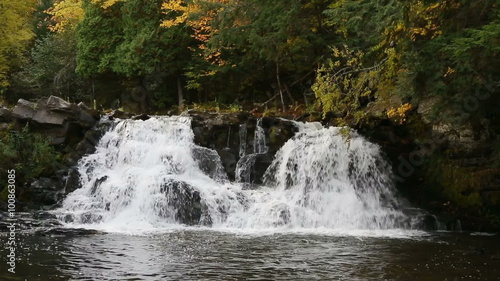 Powerhouse Falls, a waterfall near L'Anse in Michigan's western Upper Peninsula, spalshes over rocks with twin cascades. photo