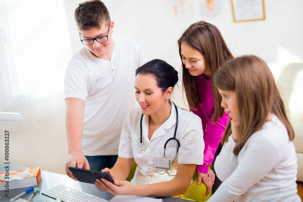 Female doctor and patient teenagers discussing health issues. Medical examination. Female doctor and patient teenagers discussing health issues. Medical examination.