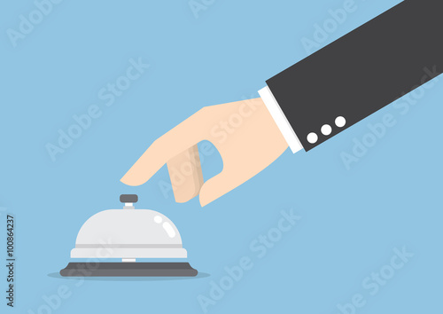Businessman hand ringing in service bell