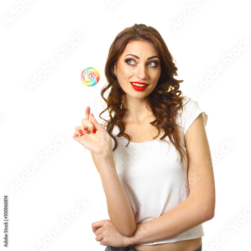 sexy girl licking a lollipop. Beautiful woman with creative makeup holding a candy. pretty smiling brunette girl with a lollipop in her hand