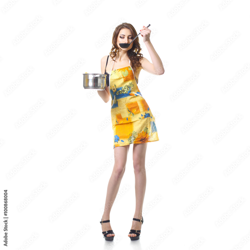 housewife tries a soup. woman in an apron with a saucepan. sexy girl in lingerie having fun with saucepan housewife tries a soup. woman in an apron with a saucepan. sexy girl in lingerie having fun with saucepan
