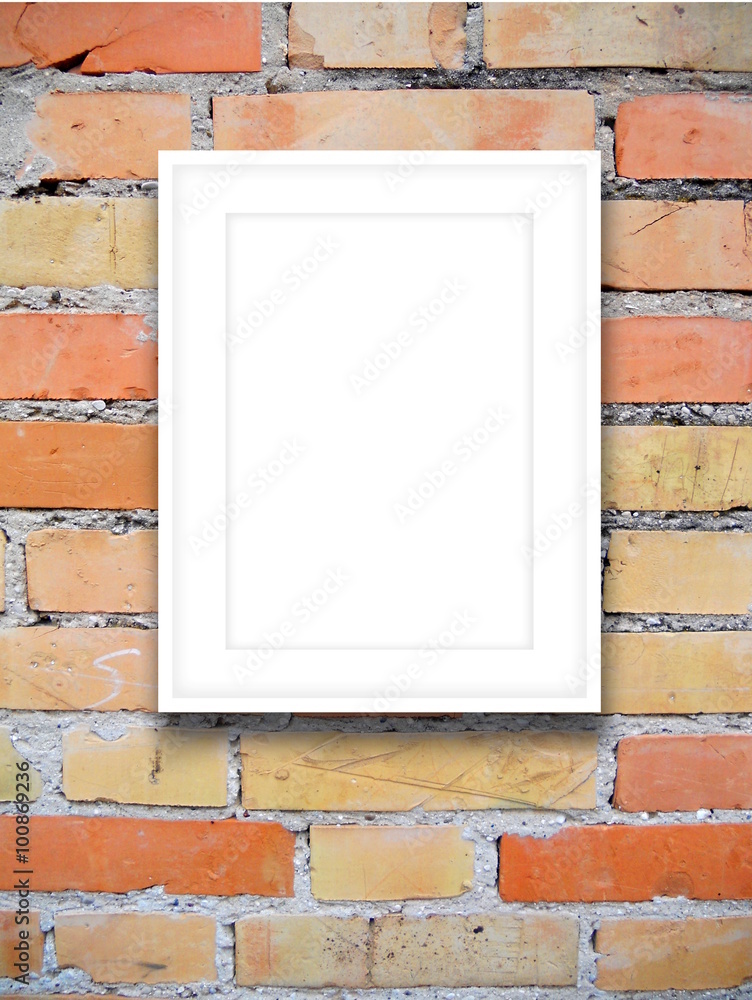 Close-up of one white picture frame on orange brick wall background Close-up of one white picture frame on orange brick wall background