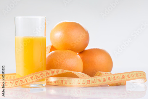 Oranges, fresh juice and measuring tape. 