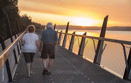 older couple walking at sunset