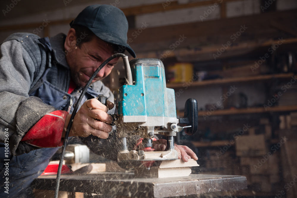Carpenter milling machine processes the wood element Carpenter milling machine processes the wood element