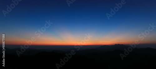 Panorama of colorful sky above mountain just before sunrise