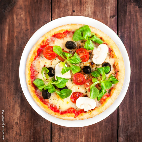 Pizza with cheese, mushrooms and olives, top view