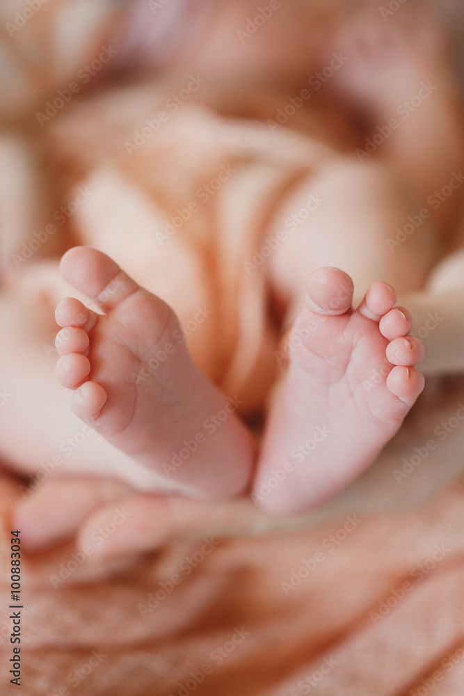 Children's legs on a mother's palm Children's legs on a mother's palm