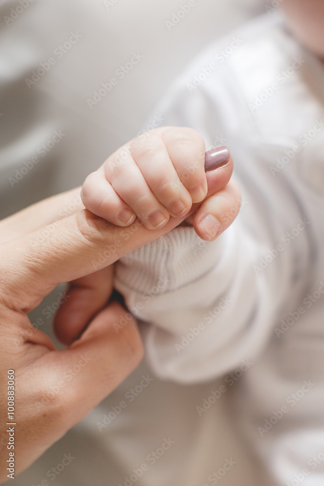 Newborn baby holding mother's finger Newborn baby holding mother's finger