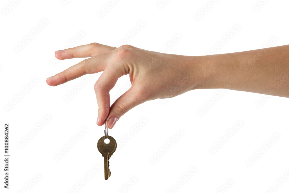 Close up view of hand holding key to a dream house isolated on w Close up view of hand holding key to a dream house isolated on w