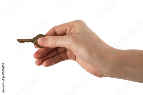 Close up view of hand holding key to a dream house isolated on w