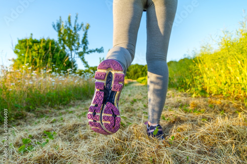 Woman running at sunset in a field