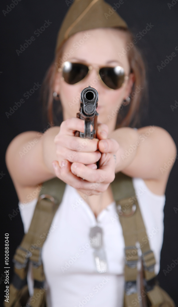 sexy young woman posing in WW2 military uniform and a weapon sexy young woman posing in WW2 military uniform and a weapon