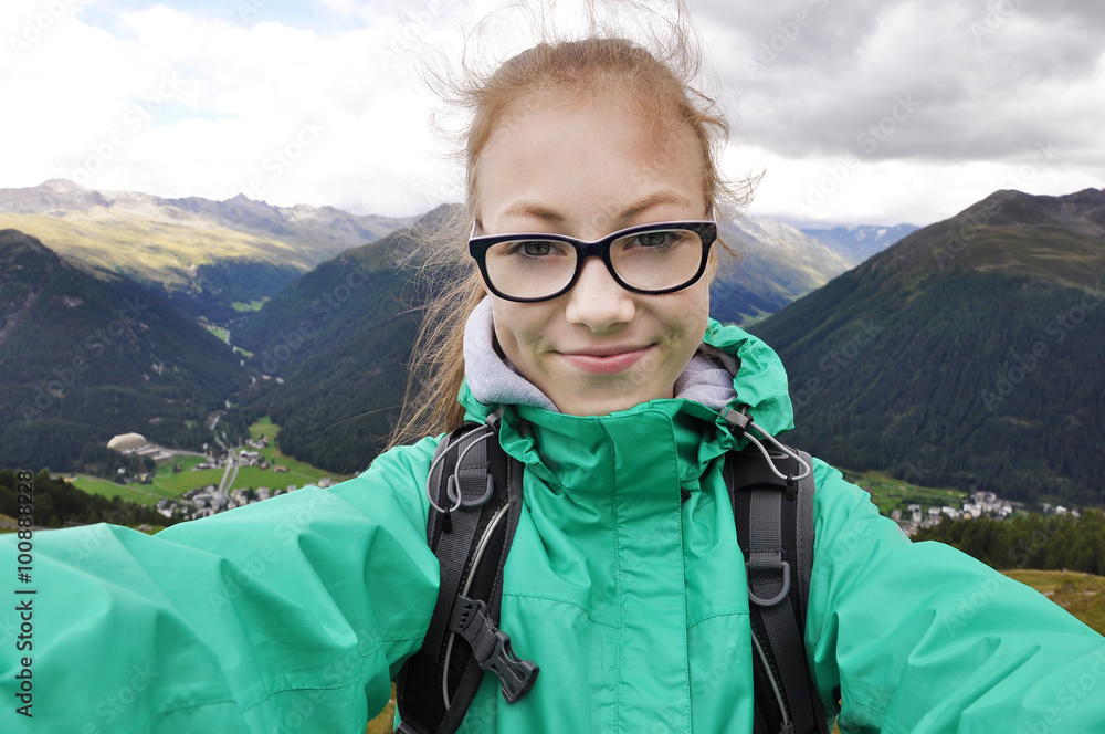 Young girl taking selfie in the mountains