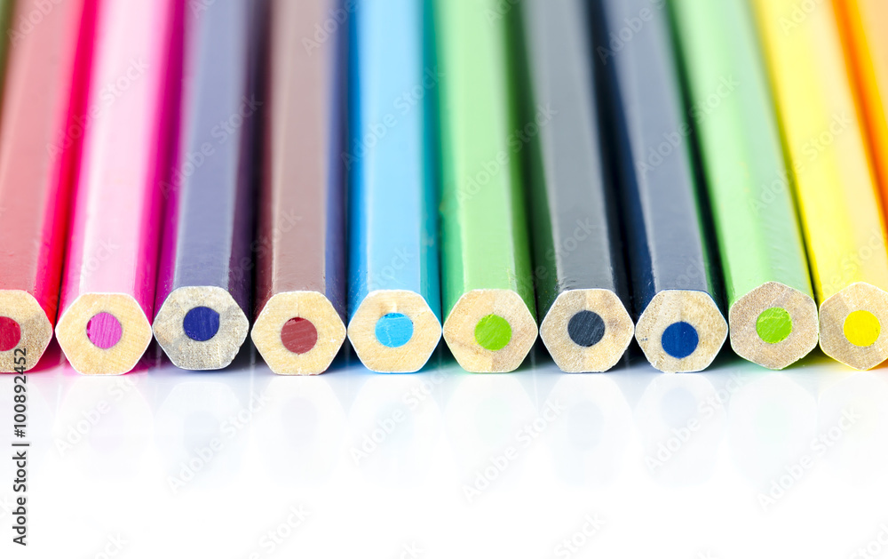 Many colored pencils aligned with back on white background Many colored pencils aligned with back on white background
